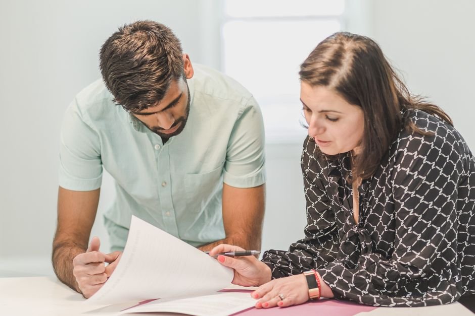 Two people meeting across a desk for a consultation